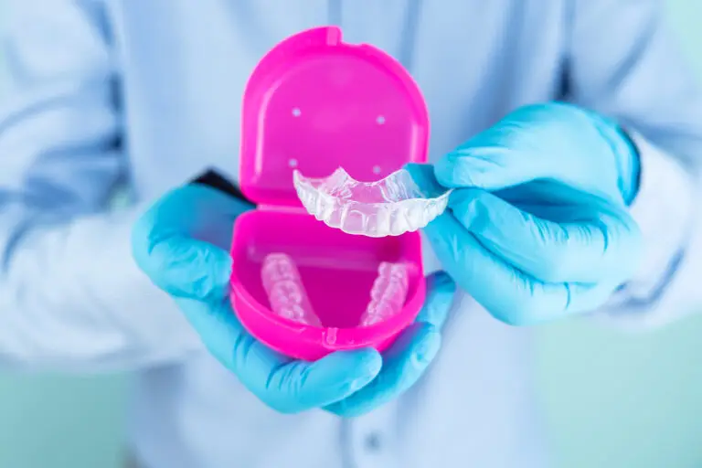 Doctor showing a dental splint in pink box